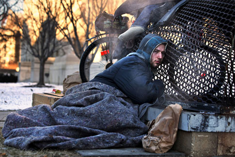 Jan. 4, 2014. Nicholas Simmons, 20, of Greece, N.Y., warms himself on a steam grate with three homeless men by the Federal Trade Commission, just blocks from the Capitol, during frigid temperatures in Washington.