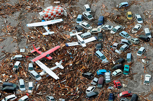 Cars and airplanes rest among debris from the tsunami at Sendai Airport
in northeastern Japan.