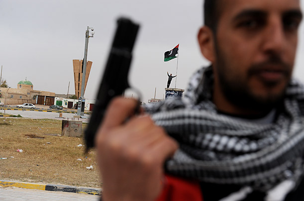 A rebel fighter brandishes his handgun in the eastern Libyan city of
Ajdabiya.