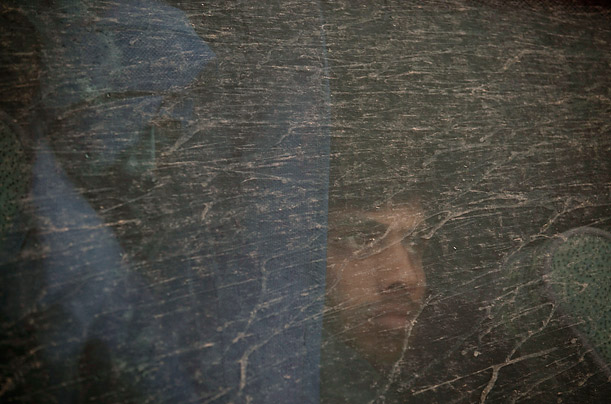A Bangladeshi evacuee from Libya peers out the window of a bus at the
Tunisian-Libyan Border.