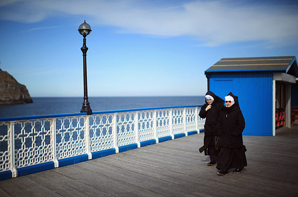 Nuns enjoy a bracing walk along the Llandudno Pier in Llandudno, United Kingdom. 
