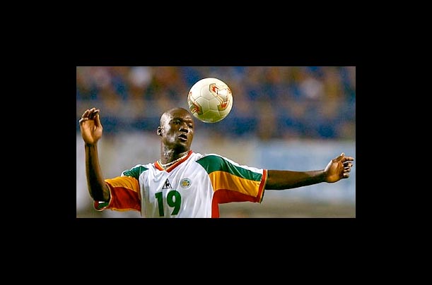 Senegalese midfielder Papa Bouba Diop heads the ball during his opening game with France for the 2002 FIFA World Cup Korea/Japan in Seoul