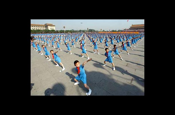 Thousands of Chinese children perform an exercise routine at Tiananmen Square in Beijing