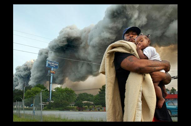 Darryl Brown embraces his daughter as they evacuate Richfield Lodge in Conyers, Georgia as a fire burns in a chemical warehouse