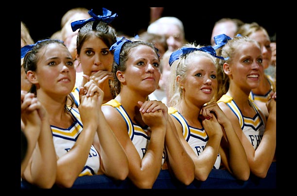 Francis Howell High School cheerleaders watch George W. Bush during a rally at the Family Arena in St. Charles, Missouri