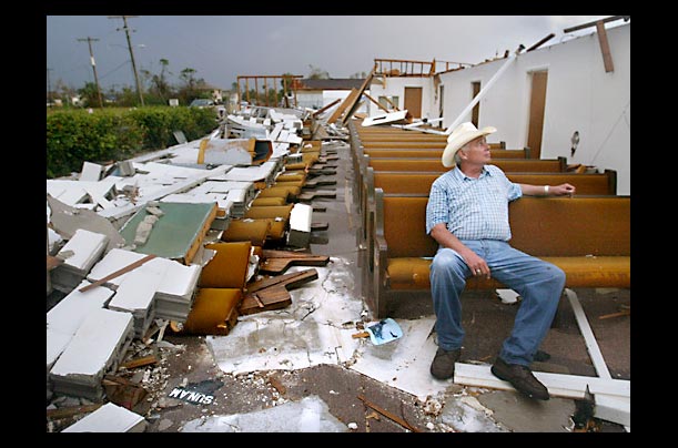 Volunteer Buddy Shipp sits in the destroyed Peace River Church of Christ in Punta Gorda, Florida
