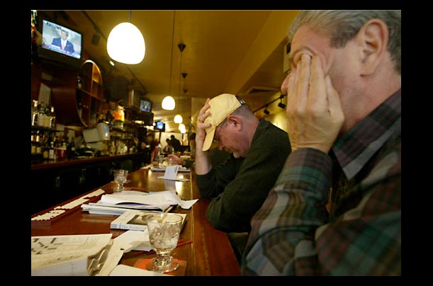 Supporters bow their heads during Kerry's concession speech in Snooky's pub in the Park Slope neighborhood of Brooklyn, New York