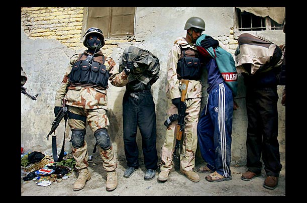 Iraqi soldiers detain suspects during a patrol with U.S. Army 1st Cavalry in the Haifa Street neighborhood of Baghdad