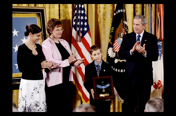 David Smith holds the Medal of Honor presented to him by President Bush in the White House