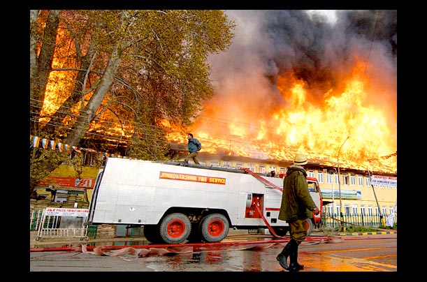 Indian firefighters arrive to put out the fire at a Tourist Reception Center