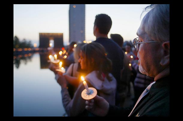 A man holds a candle during prayer services at Oklahoma City National Memorial