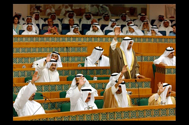 Kuwaiti Members of Parliament vote during a session that passed a historic law granting women the right to vote and run in elections