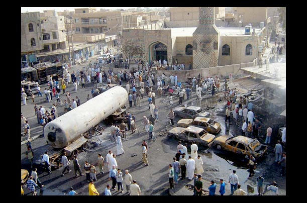 Iraqis gather at the scene of a massive bomb attack in the town of mMsayyib 40 miles south of Baghdad