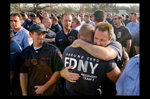 New York Fire Department firefighters embrace during a mass on anniversary of the September 11 attacks on the World Trade Center in New Orleans