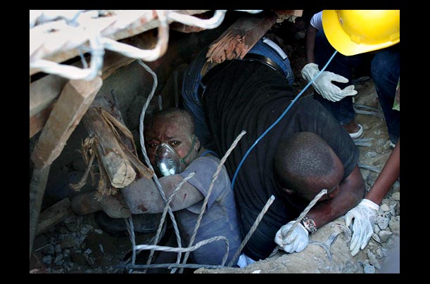 Rescue workers pull survivors from underneath a collapsed construction building in Nairobi