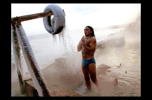 A man takes a shower at a frozen hot mineral spring in the Black Sea town of Varna
