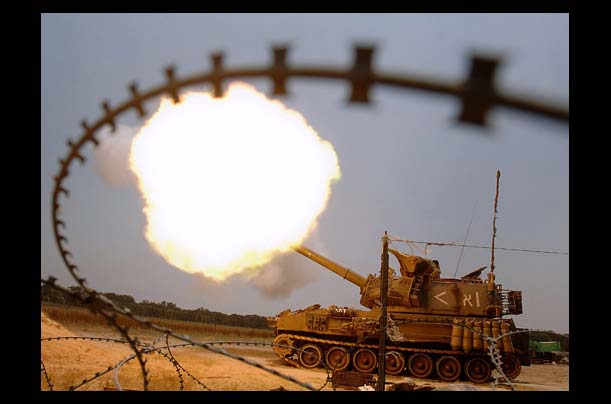 Israeli mobile artillery unit fires a shell towards the Gaza Strip