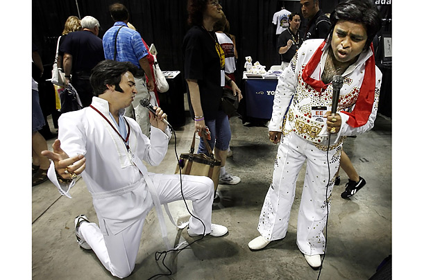 Elvis Presley impersonators Steve Rosati, left, and Keshav Patel, who both happened to have traveled to Memphis, from Montreal, sing a karaoke duet at the Elvis Expo at the Cook Convention Center in Memphis.