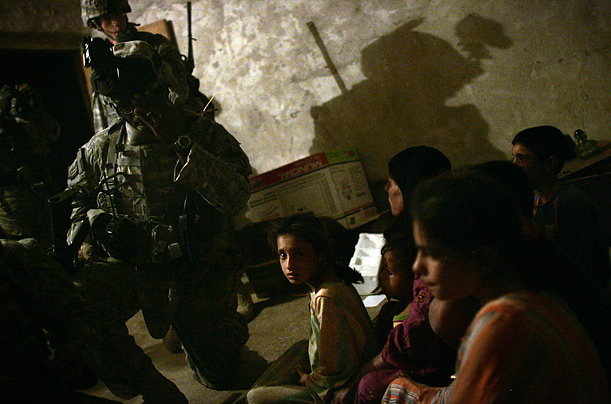 Soldiers from 3-509 Para-Infantry Regiment stand guard over an Iraqi family while searching a home during Operation Marne Husky along the Tigris River south of Baghdad.

  

