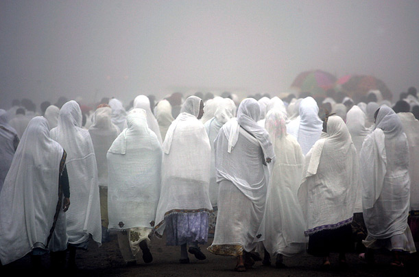 Ethiopian women follow men in a procession through early morning mist to celebrate a special pre-millennium mass at an Orthodox church in the northern city of Axum. Ethiopia celebrated the year 2000 on Sept. 11, 2007.