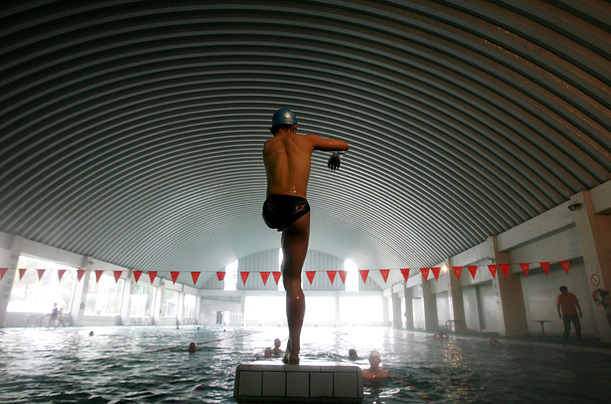 A disabled athlete prepares to jump into a pool as he attends a training session at the South of the Clouds Swimming Club in Kunming, China. The club, the first of its kind in China, aims to provide swimming facilities and