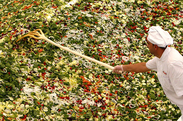 A cook prepares the world's biggest green salad, breaking a Guinness World Record, during an event in the Spanish southern village of Pulpi. The salad was made with more than 6500 kg of vegetables.