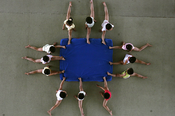 Children practice splits at the Li Xiaoshuang Gymnastics School in Xiantao, China. More than 60 children aged between 3 and 10 from all over China train at the boarding school.