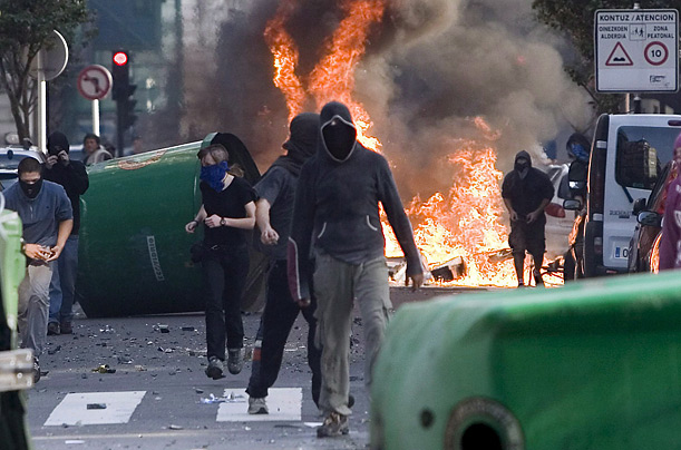 Supporters of left-wing groups set fire to containers in San Sebastian, Spain. Protesters were trying to disturb a rally staged by the extreme right party Falange on National Day. 
