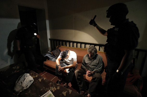 Members of Mexico's Federal Investigative Agency (AFI) arrest men on suspicion of drug possession during an anti-narcotics operation in the Polanco district in Mexico City.