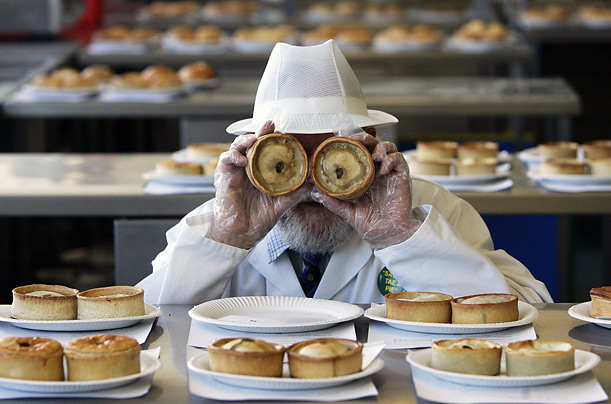 World Pie Championship jury member John Young poses with two scotch pies during the judging of the competition in Dunfermline, Scotland.