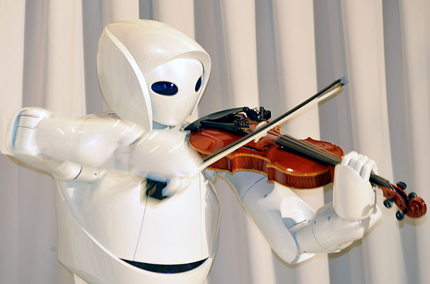 A Toyota robot plays the violin during a press unveiling in Tokyo.