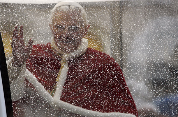 Pope Benedict XVI waves from inside the popemobile after praying near the Spanish Steps in Rome.