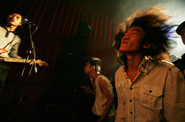 Chinese fans dance during a show by the rock group Joyside at D-22 Bar in Beijing.
