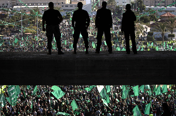 Hamas security officers stand guard as thousands of Hamas supporters gather during a rally marking the group's 20th Anniversary in Gaza City.