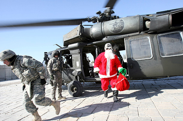 A U.S. soldier dressed as St. Nick arrives at Hammer Base in Baghdad on Christmas Eve. 
