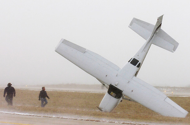 Authorities investigate the scene of an aircraft accident in Kenosha, Wisconsin. The plane landed safely, but overturned in heavy wind moments later. No one was injured. 

