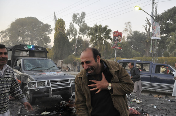 A man weeps over the site of the bomb blast that killed former Pakistani Prime Minister Benazir Bhutto.