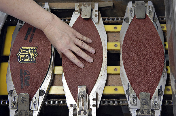 A worker at the Wilson Sporting Goods factory in Ada, Ohio, creates one of the 72 footballs to be used in the Super Bowl.