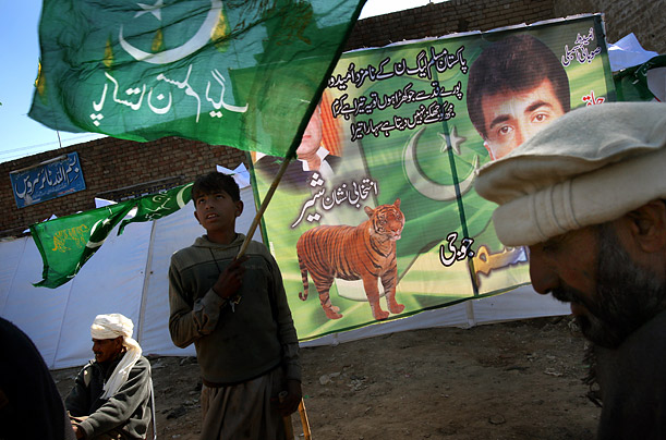 Supporters of the former prime minister of Pakistan, Nawaz Sharif, gather with flags and banners during a rally in Chakwal, Pakistan. Pakistanis will go to the polls 
