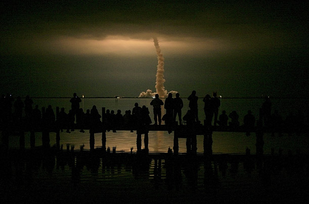 Spectators watch the space shuttle Endeavour launch from the Kennedy Space Center in Cape Canaveral, Florida.