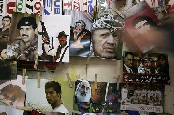A Palestinian vendor displays photographs of Arab leaders, soccer players and celebrities at his show in the West Bank city of Ramallah.