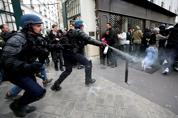 Policemen spray tear gas at protesters during a student demonstration against higher education reform and reduction of teaching positions in high schools, Paris, France.
