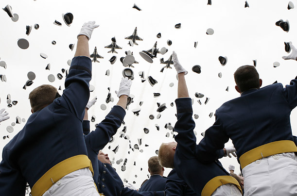 F-16's fly overhead as cadets toss their caps into the air at the conclusion of the Air Force Academy graduation ceremony in Colorado Springs, Colorado.