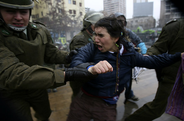 A student is detained by riot police during a rally to protest proposed education reforms, in Santiago, Chile.