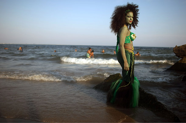 A reveler dressed as a mermaid poses for a photo at the 25th annual Coney Island Mermaid Parade in the Brooklyn, New York.
