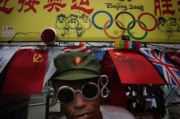 A Chinese man decorates his vehicle with Olympic motifs to promote the Olympic spirit outside of the Olympic Green in Beijing.   




