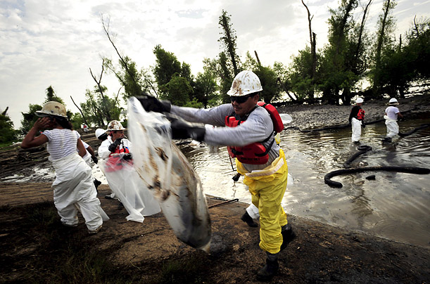 Workers toil to cleanup an oil spill on the Mississippi River in Jesuit Bend, Louisiana, after a ship collided with an oil barge, spilling thousands of barrels of fuel into the water.