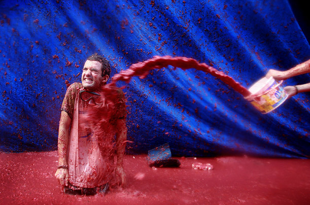 A participant gets drenched with tomato paste during the Tomatina, the annual tomato-throwing festival held in Bunol, Spain.