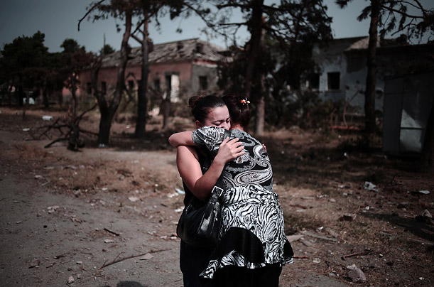 Two women sob together in front of the ruins of their home which was destroyed  by a Russian bombing in Gori, Georgia.