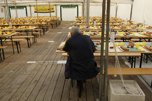 A lone man eats in a soup kitchen set up for Ramadan outside a public housing project in Paris.